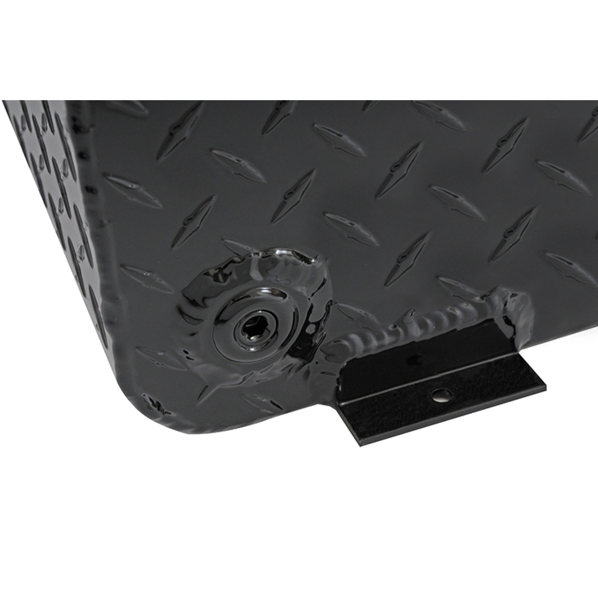 Close-up view of the corner on the Dee Zee Long Rectangle Transfer Tank BlackTread DZ92556NB, highlighting the diamond plate texture, radius curve design, lockable filler neck, and mounting tab on this durable non-rusting Brite-Tread aluminum transfer tank with gloss black powder coat finish.