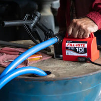 Fill-Rite FR1614 diesel fuel transfer pump connected to a drum with hose attached during active fuel transfer