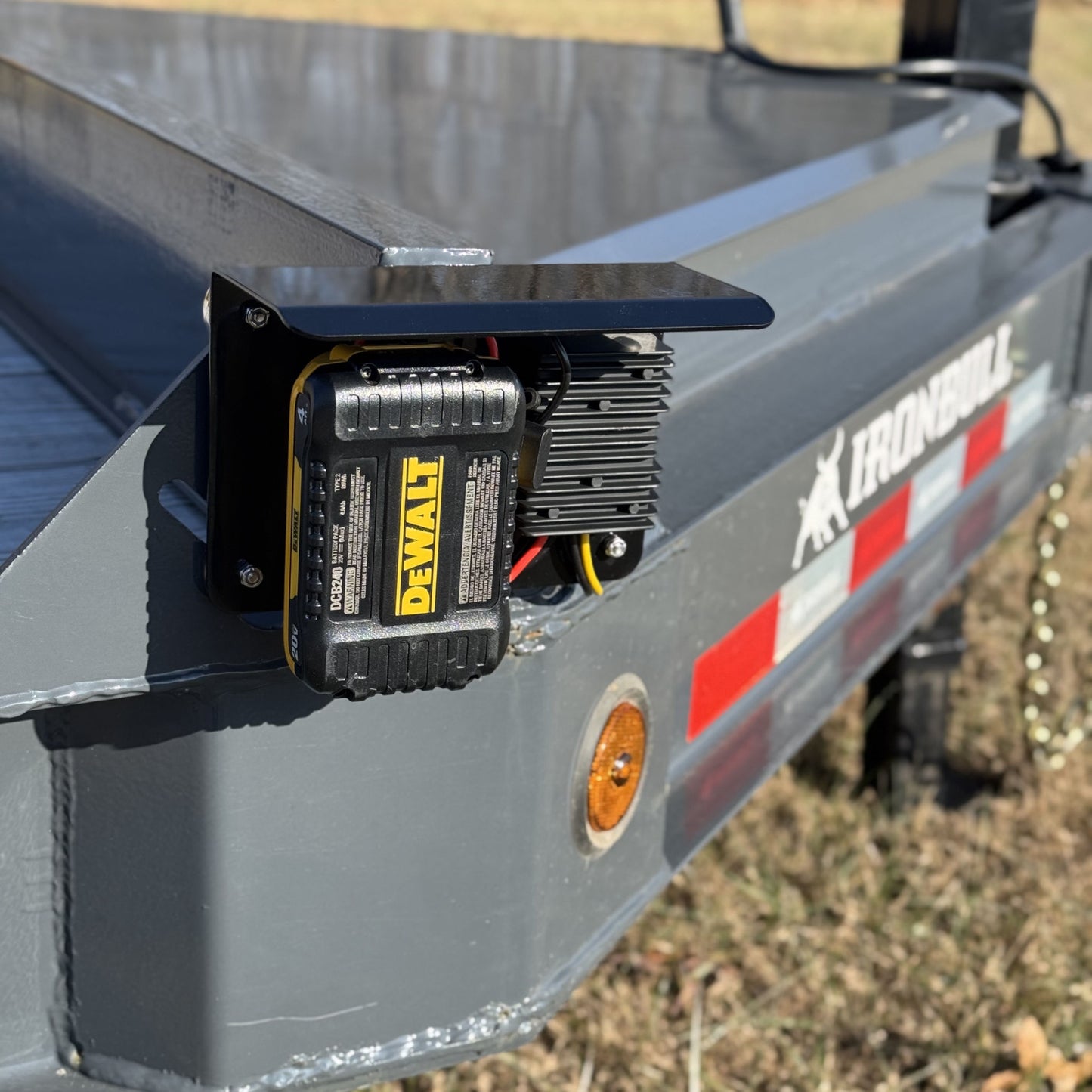 PowerMate Converter (SKU PMC1001) with DeWalt 20V battery mounted on trailer side rail