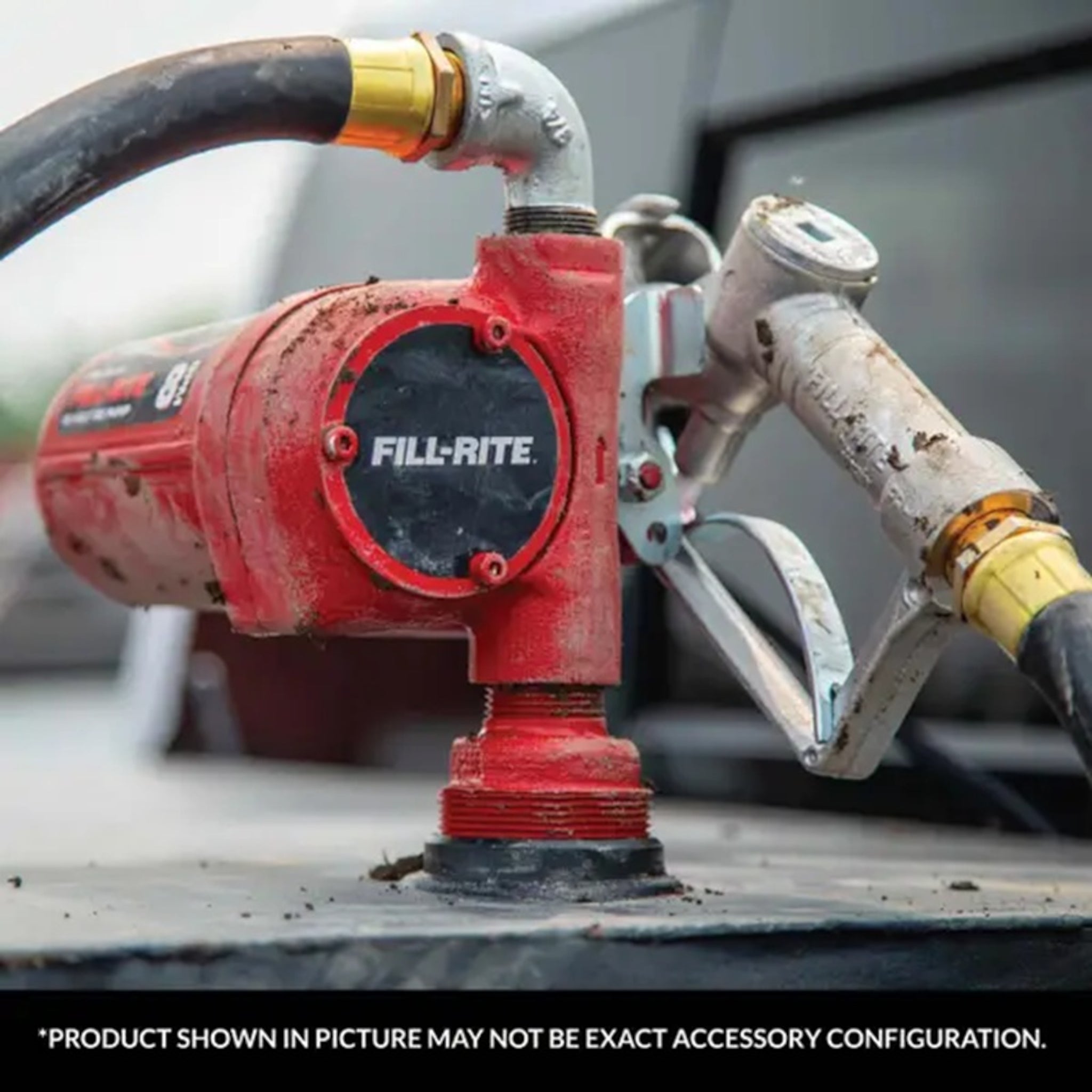 Fill-Rite FR8 12V DC rotary pump on truck: mud-covered red housing, manual nozzle, and hose for durable fuel dispensing in harsh conditions