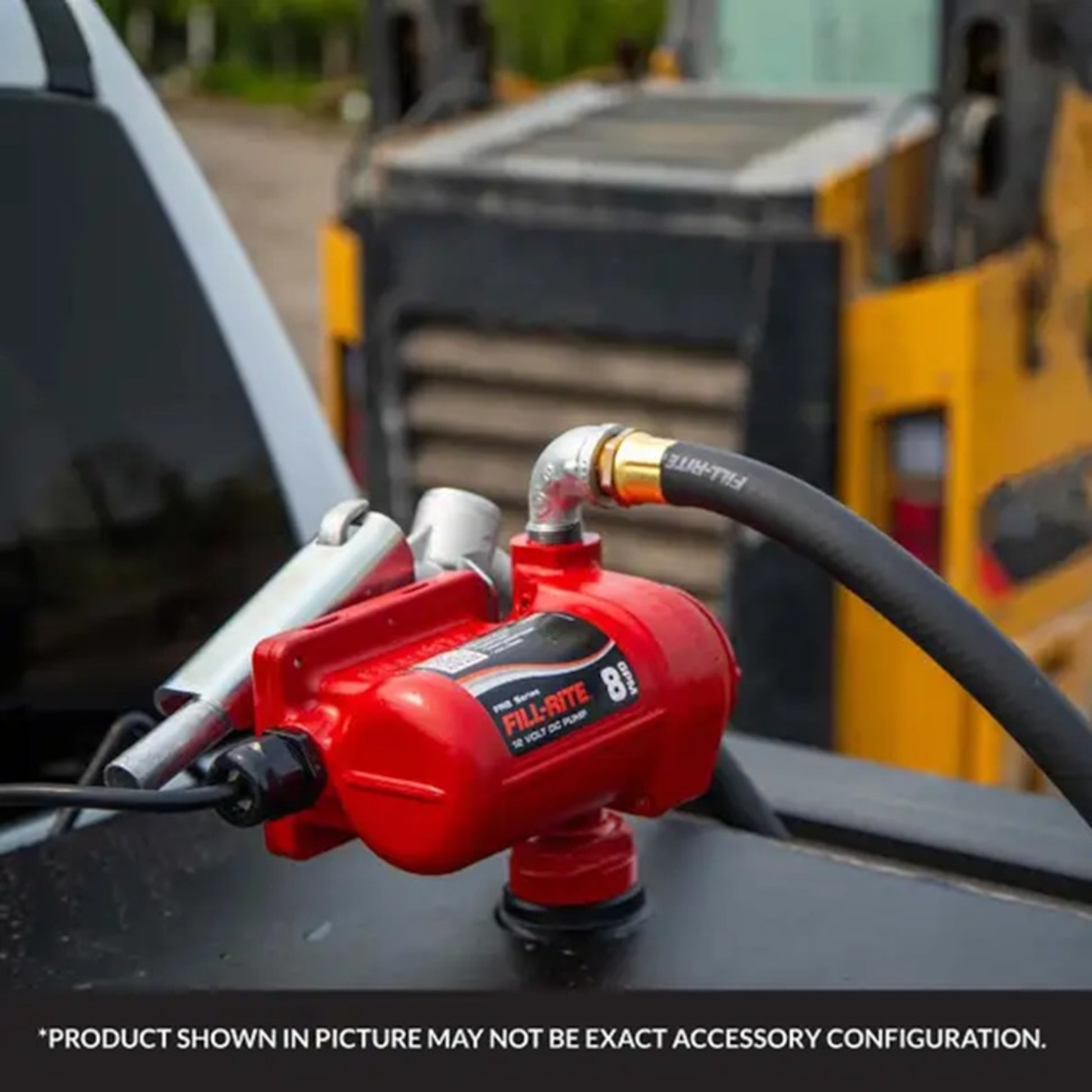 Fill-Rite FR8 12V DC fuel pump installed in pickup truck bed, red unit with hose and nozzle for mobile fuel transfer in field settings
