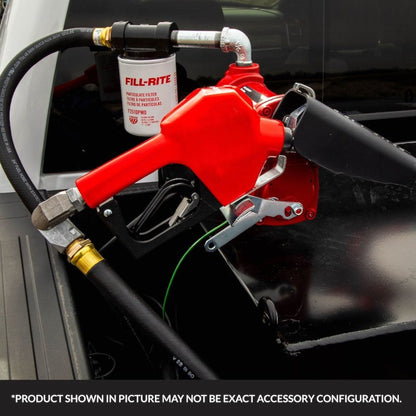 Fill-Rite SDN075RAN 3/4" red automatic gasoline nozzle mounted on fuel transfer pump with filter and hose in outdoor application; note: product shown may vary in exact accessory configuration