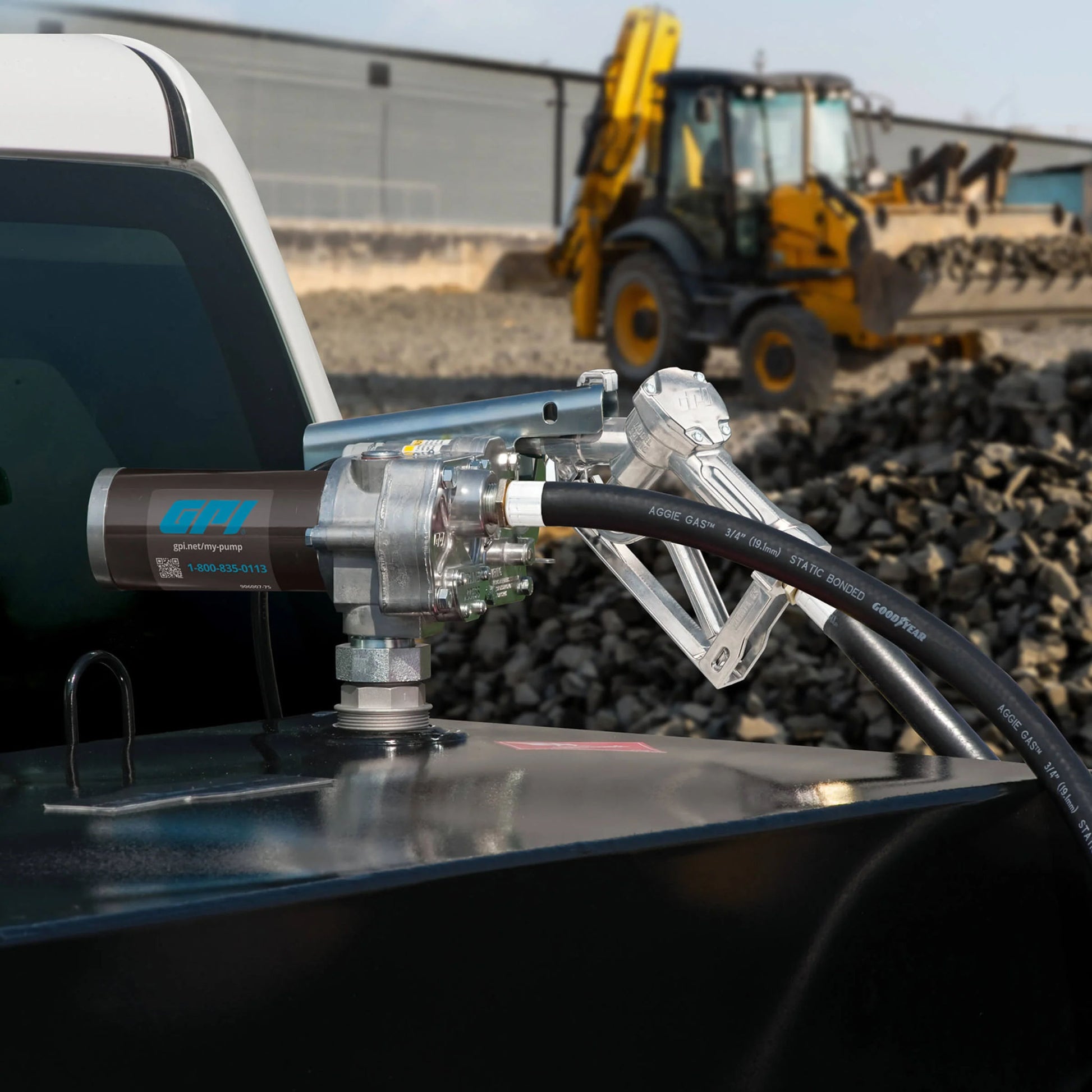 GPI M-150S-MU 12V fuel transfer pump SKU M150S-MU in use dispensing fuel on construction site with manual nozzle