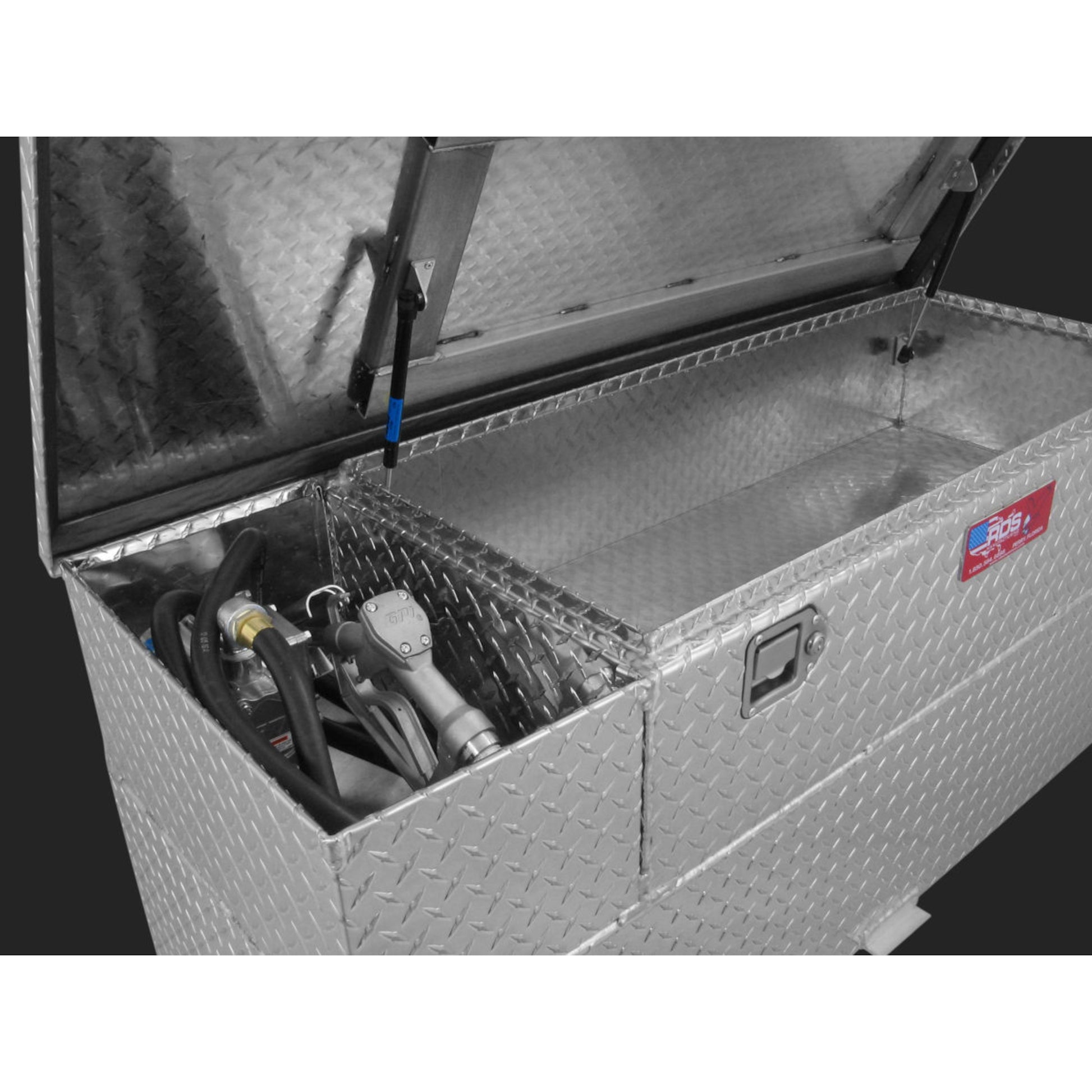 Interior view of RDS 60-gallon fuel tank/toolbox combo: organized pump installation, hoses, and storage space for auxiliary transfer efficiency.