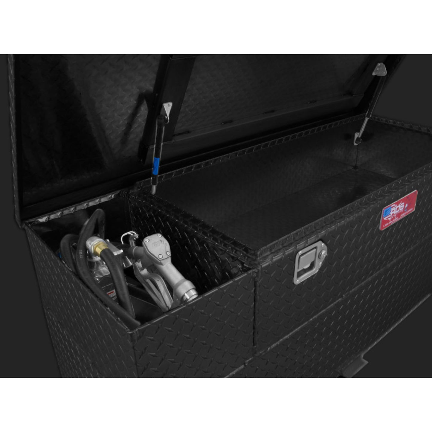 Close-up pump installation in RDS 60-gallon black transfer tank/toolbox: 12V electric pump, hose, nozzle, and secure mounting for reliable fueling.