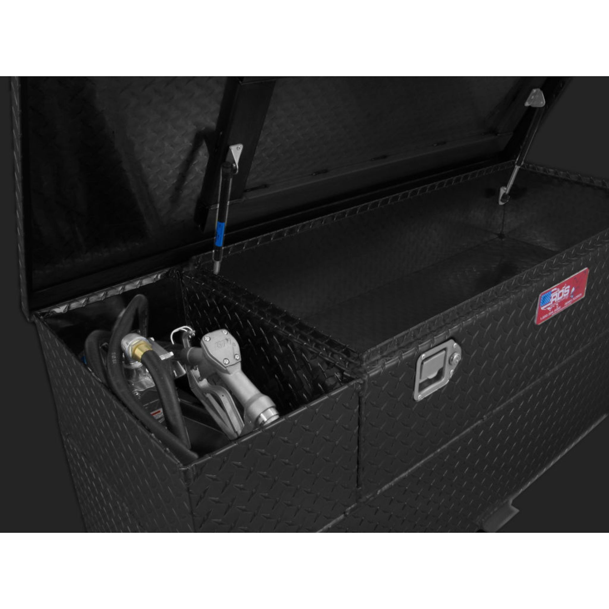 Close-up pump installation in RDS 60-gallon black transfer tank/toolbox: 12V electric pump, hose, nozzle, and secure mounting for reliable fueling.